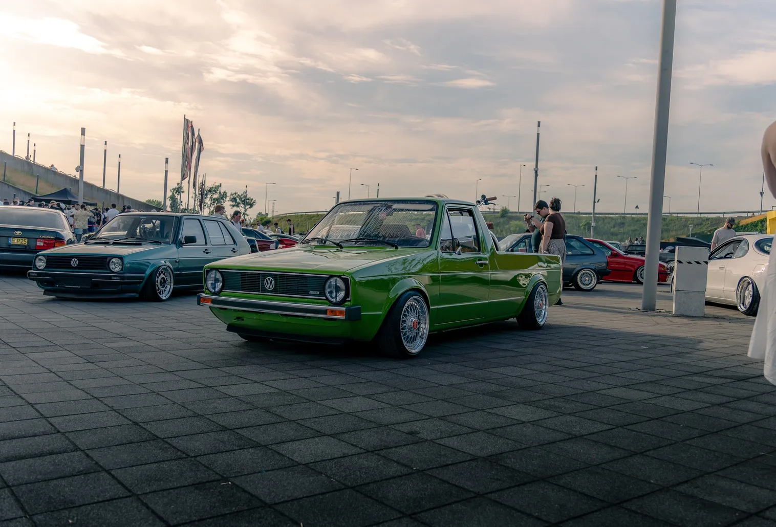 Green VW Golf Caddy pickup in evening light