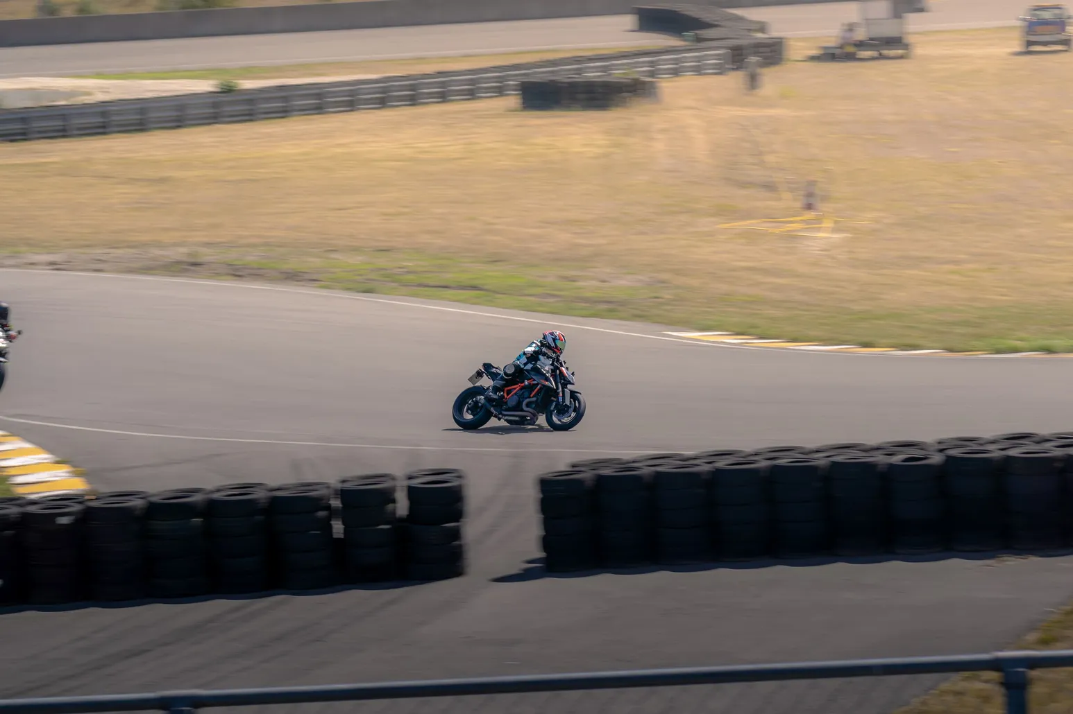 Motorcyclist cornering past the tyre wall