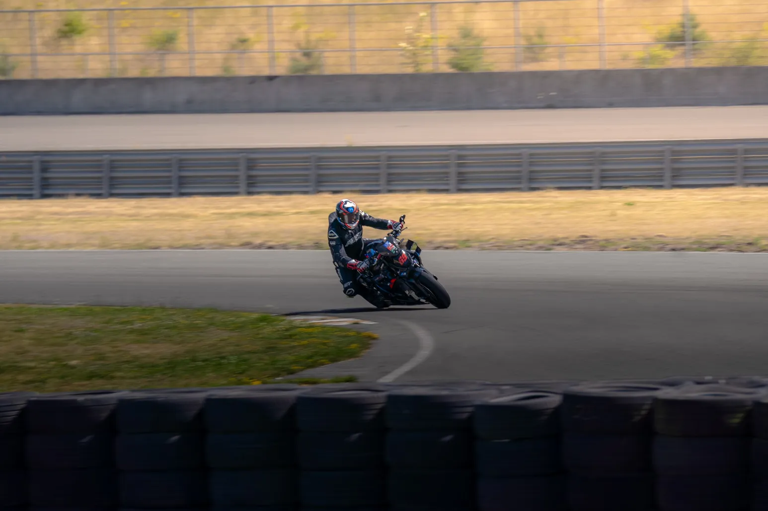 Rider in black leathers knee out in a right-hander