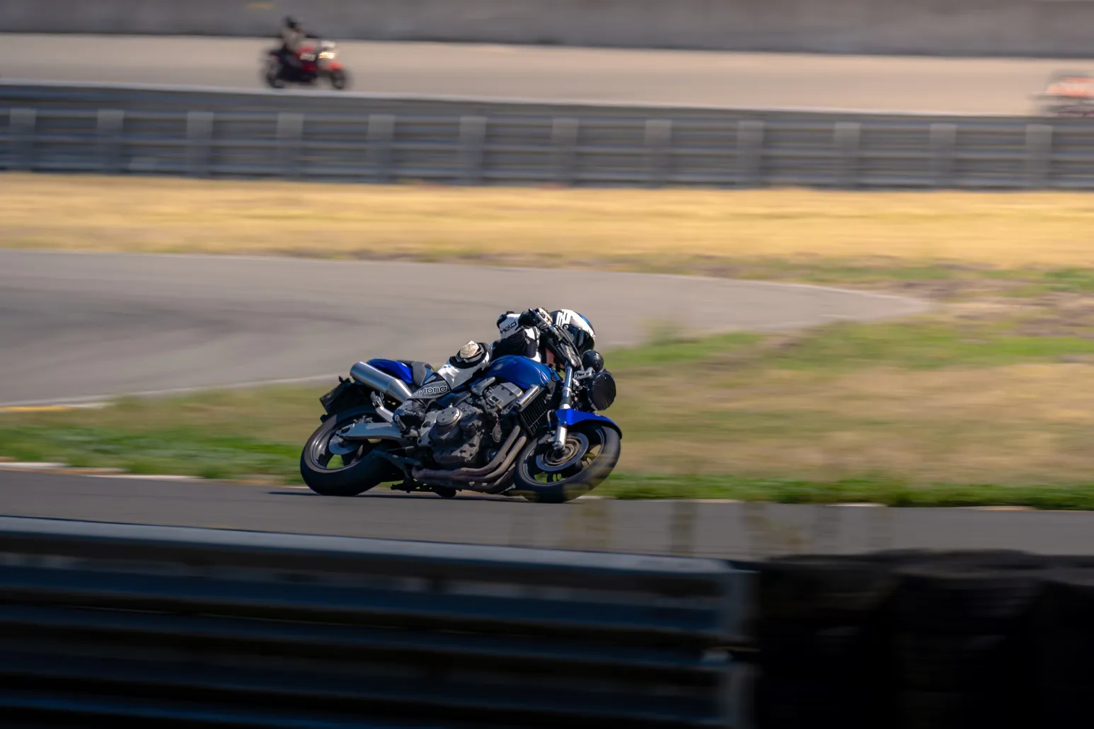 Blue and white sport bike at deep lean angle