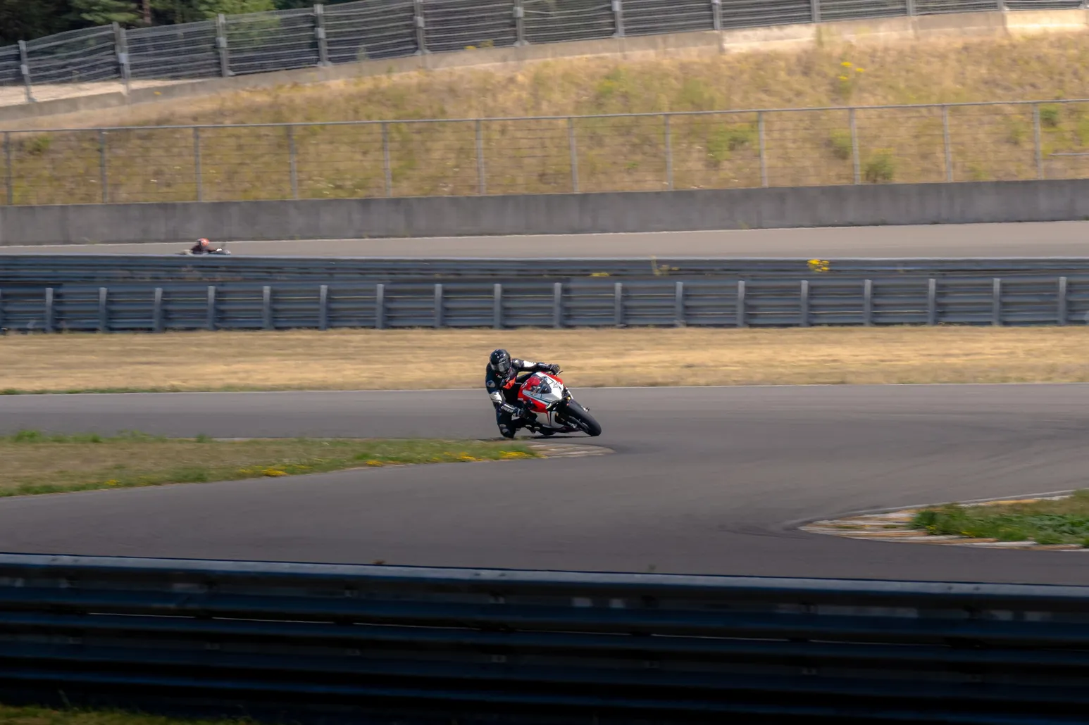 Motorcyclist leaning into a long corner