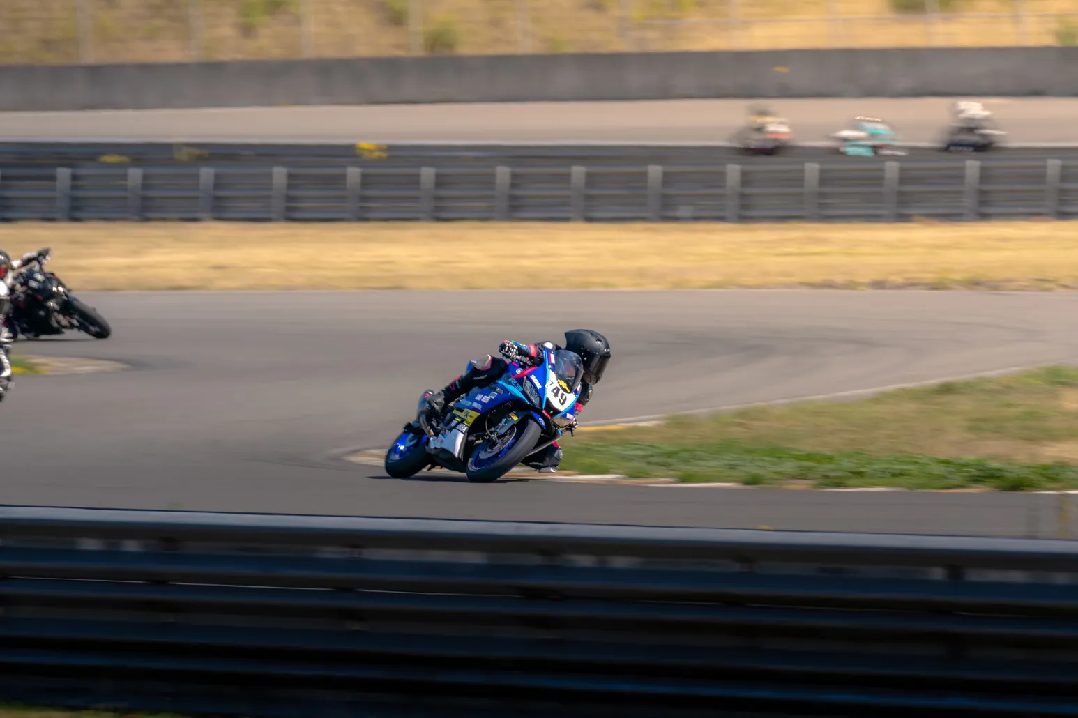 Blue sport bike knee down in a left-hander
