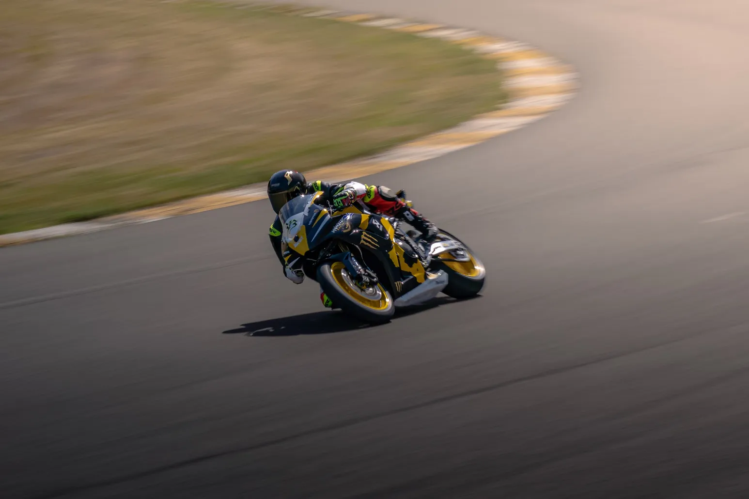 Yellow and black sport bike leaned over in a panning shot