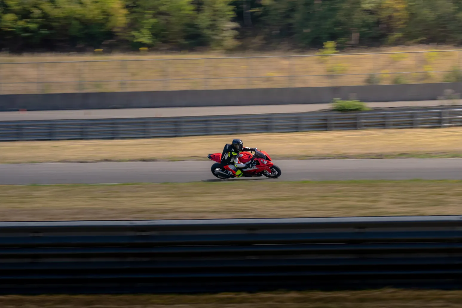 Red sport bike on the straight in a panning shot