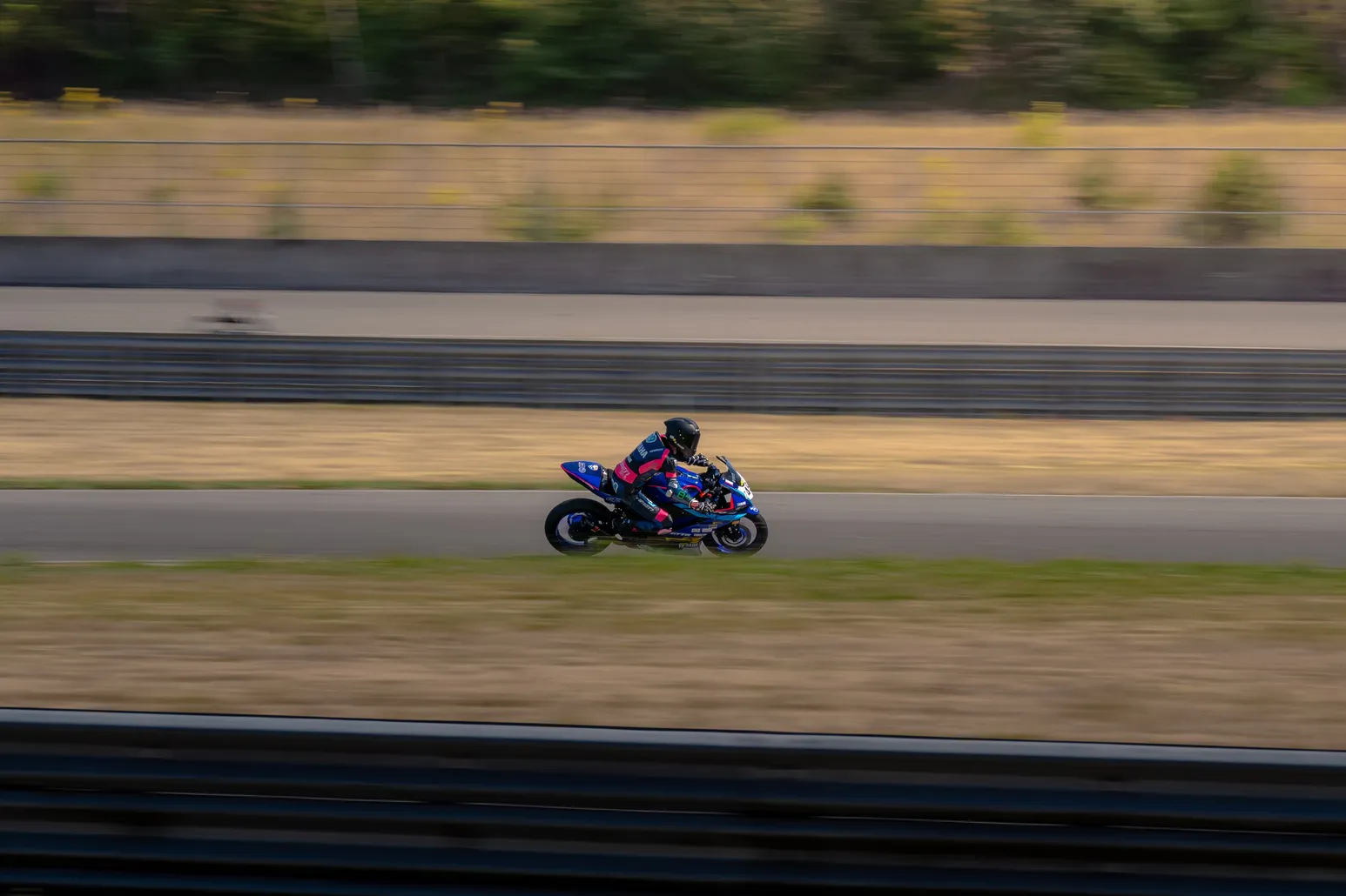Blue sport bike speeding along the straight