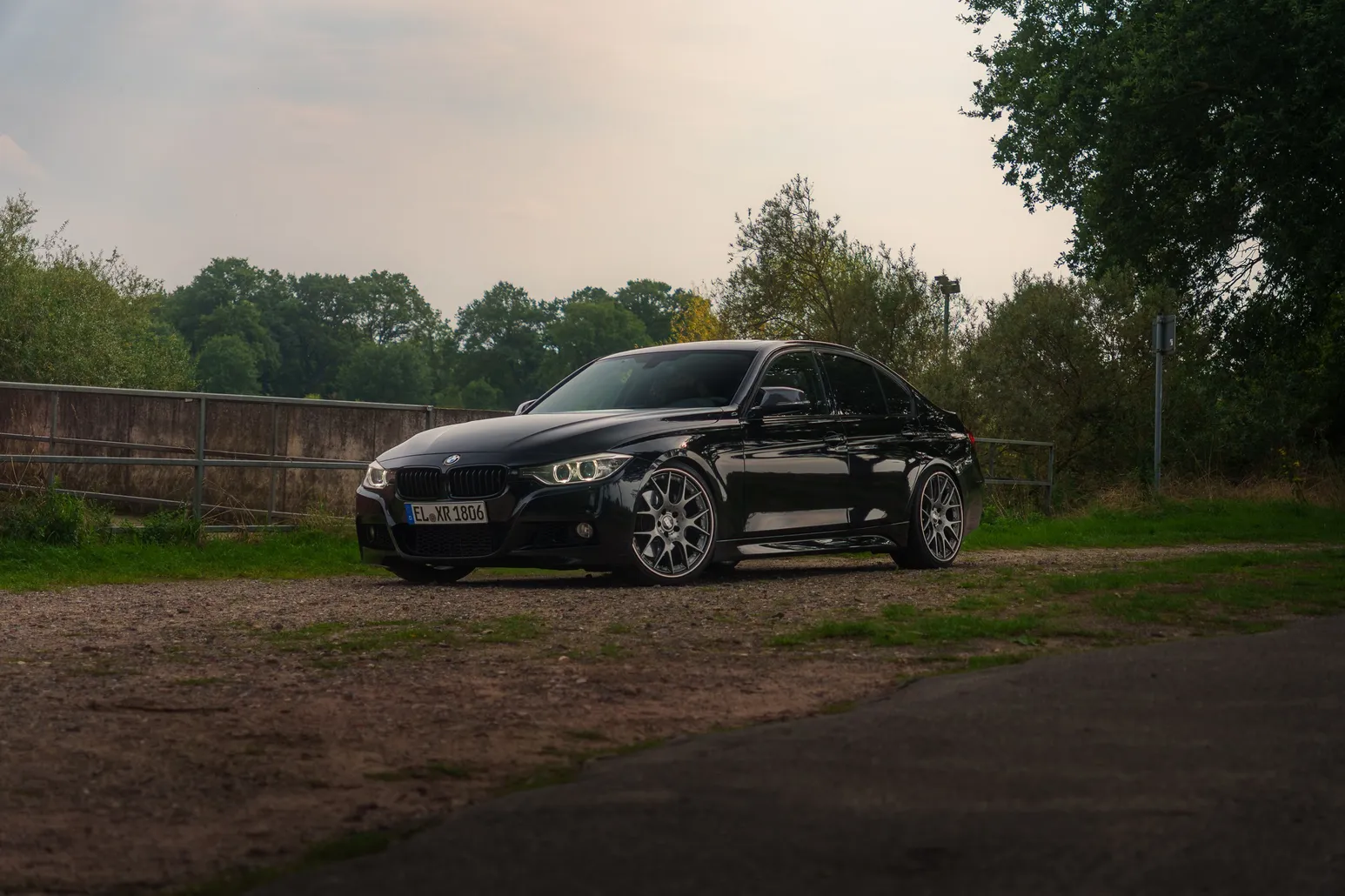 Black BMW F30 side view by the river