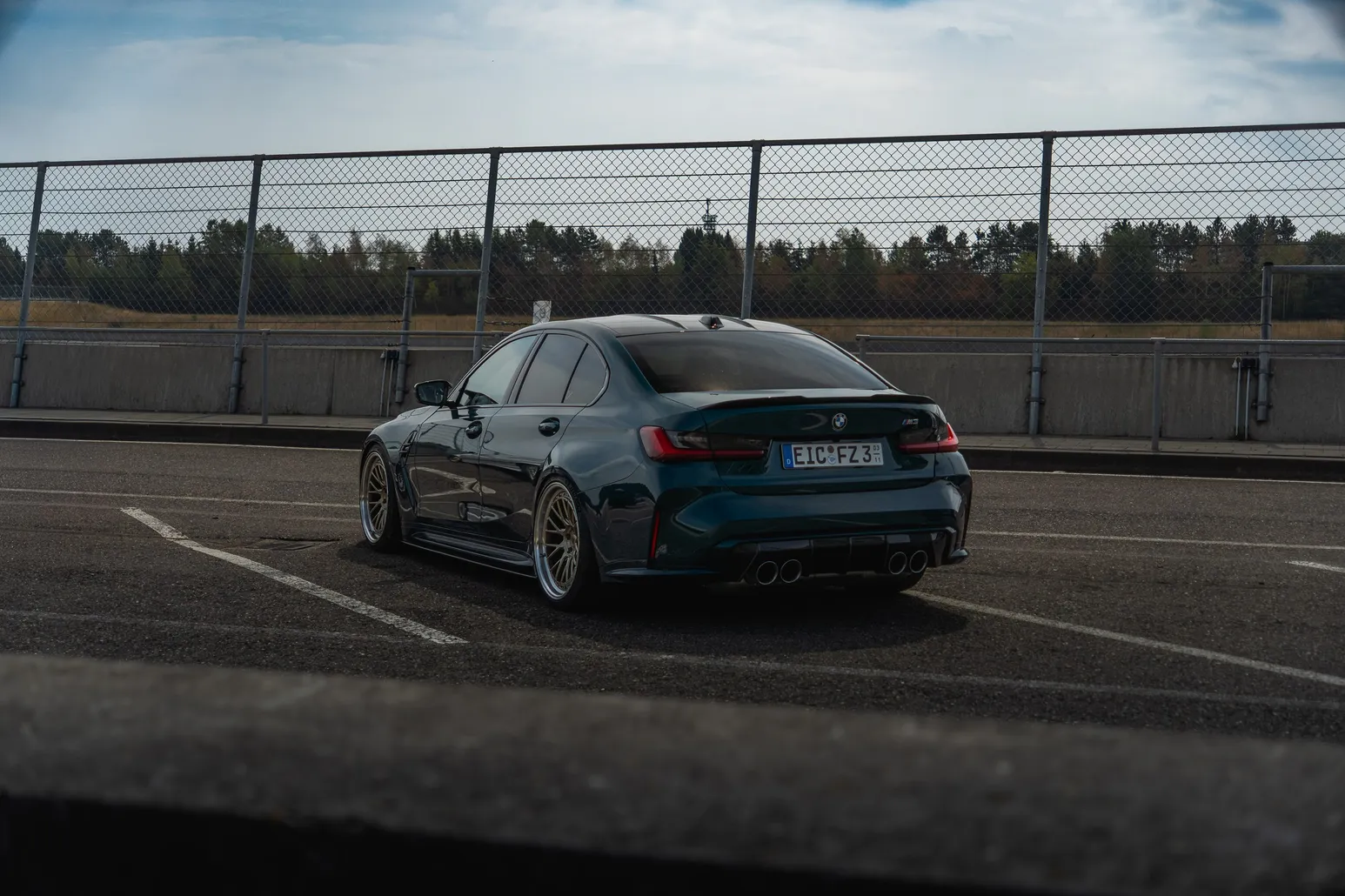 Green BMW M3 rear view in the paddock