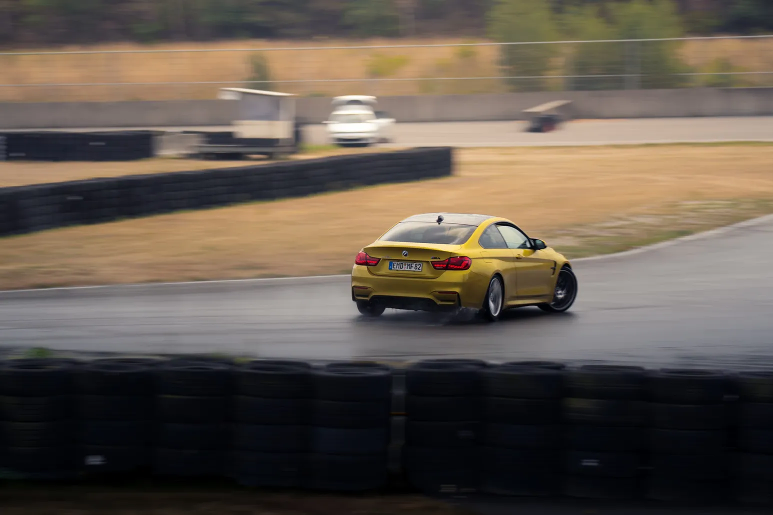 Yellow BMW M4 counter-steering out of the corner