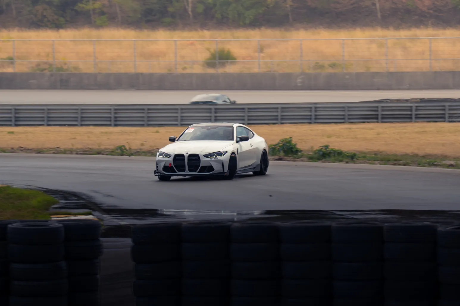White BMW M4 drifting on wet tarmac