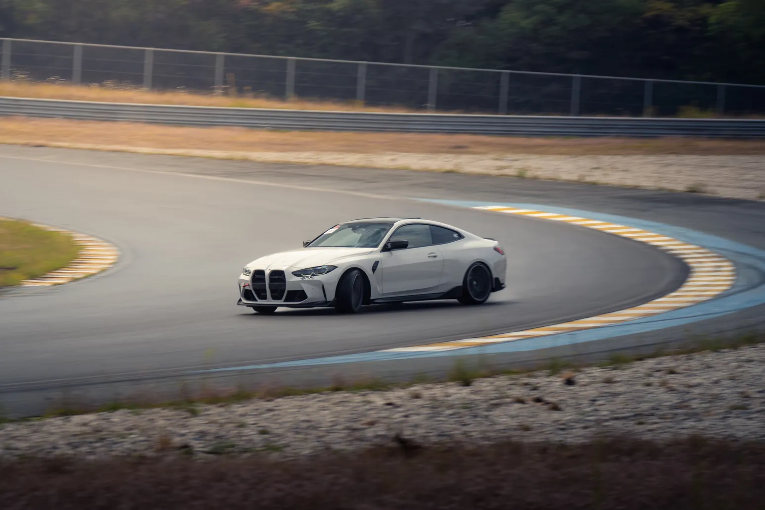 White BMW M4 drifting through the curve