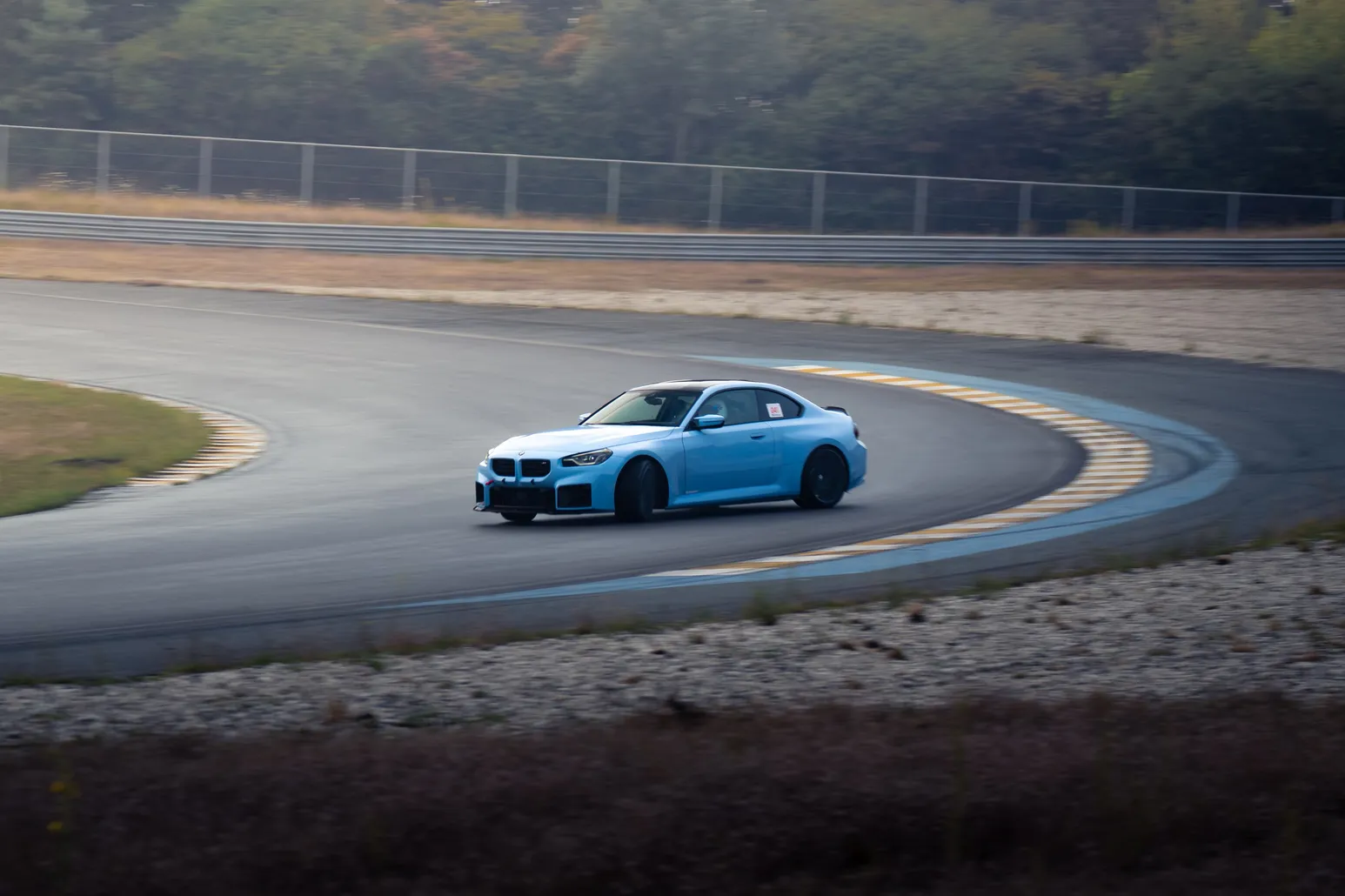 Light blue BMW M2 drifting through the corner