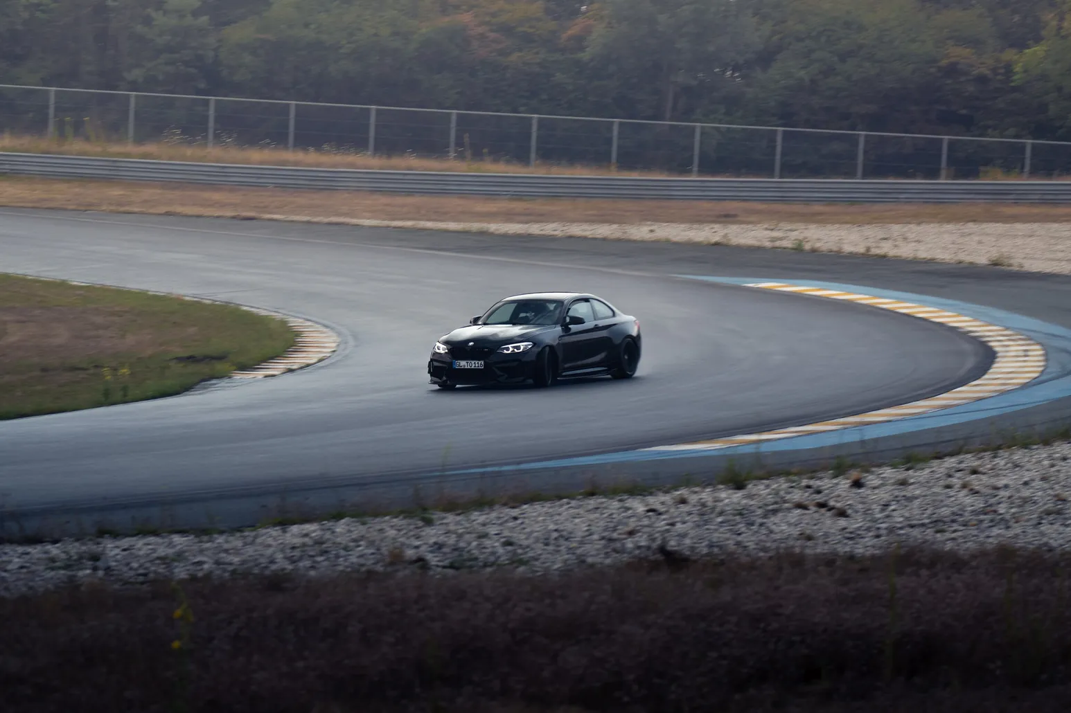Black BMW drifting through the curve