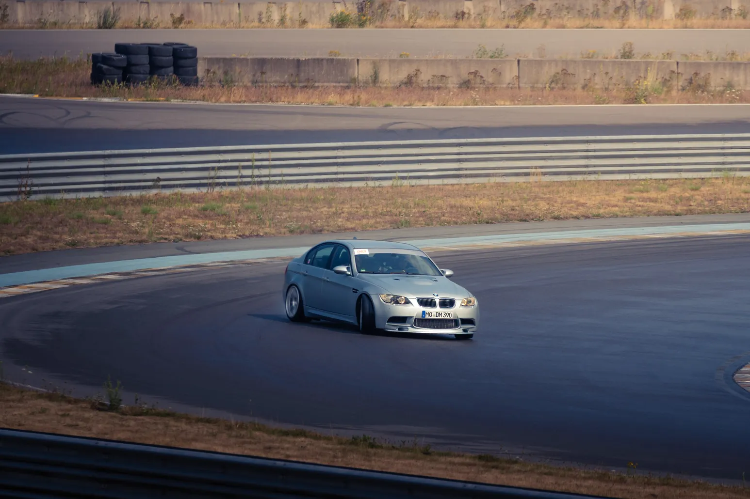 Silver BMW drifting on the far bend