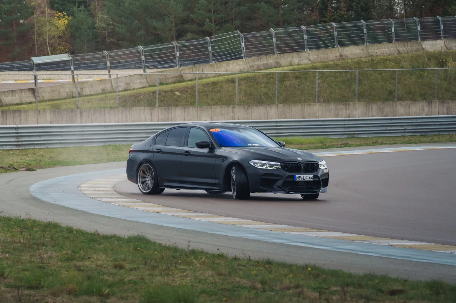 Black BMW M5 (F90) drifting through a corner
