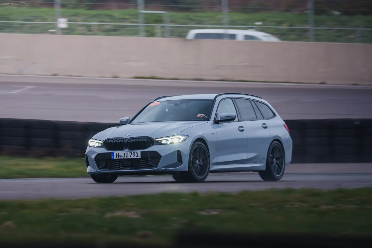 Grey BMW 3 Series Touring head-on in front of the tyre wall