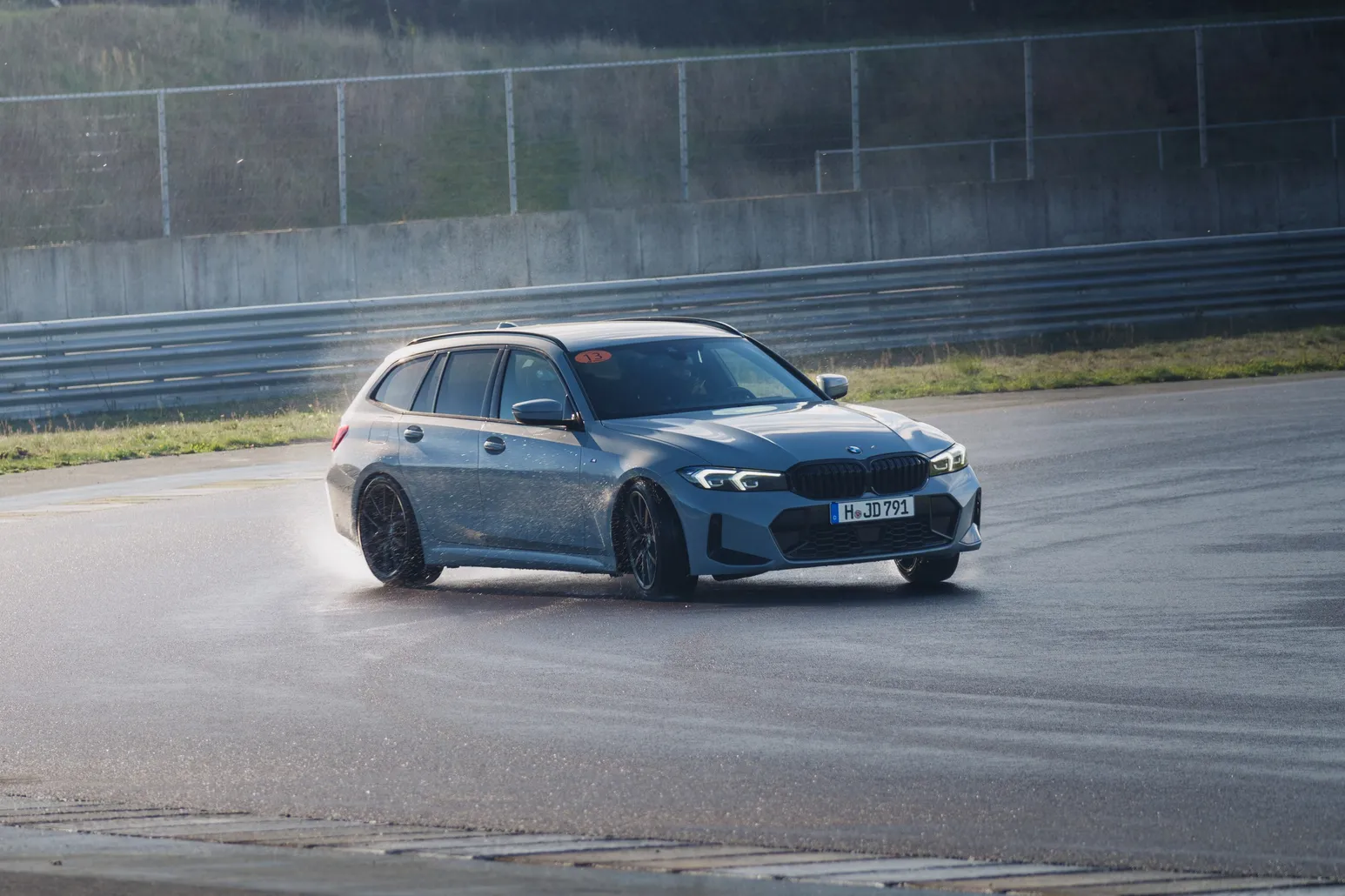 BMW 3 Series Touring drifting on the wet track