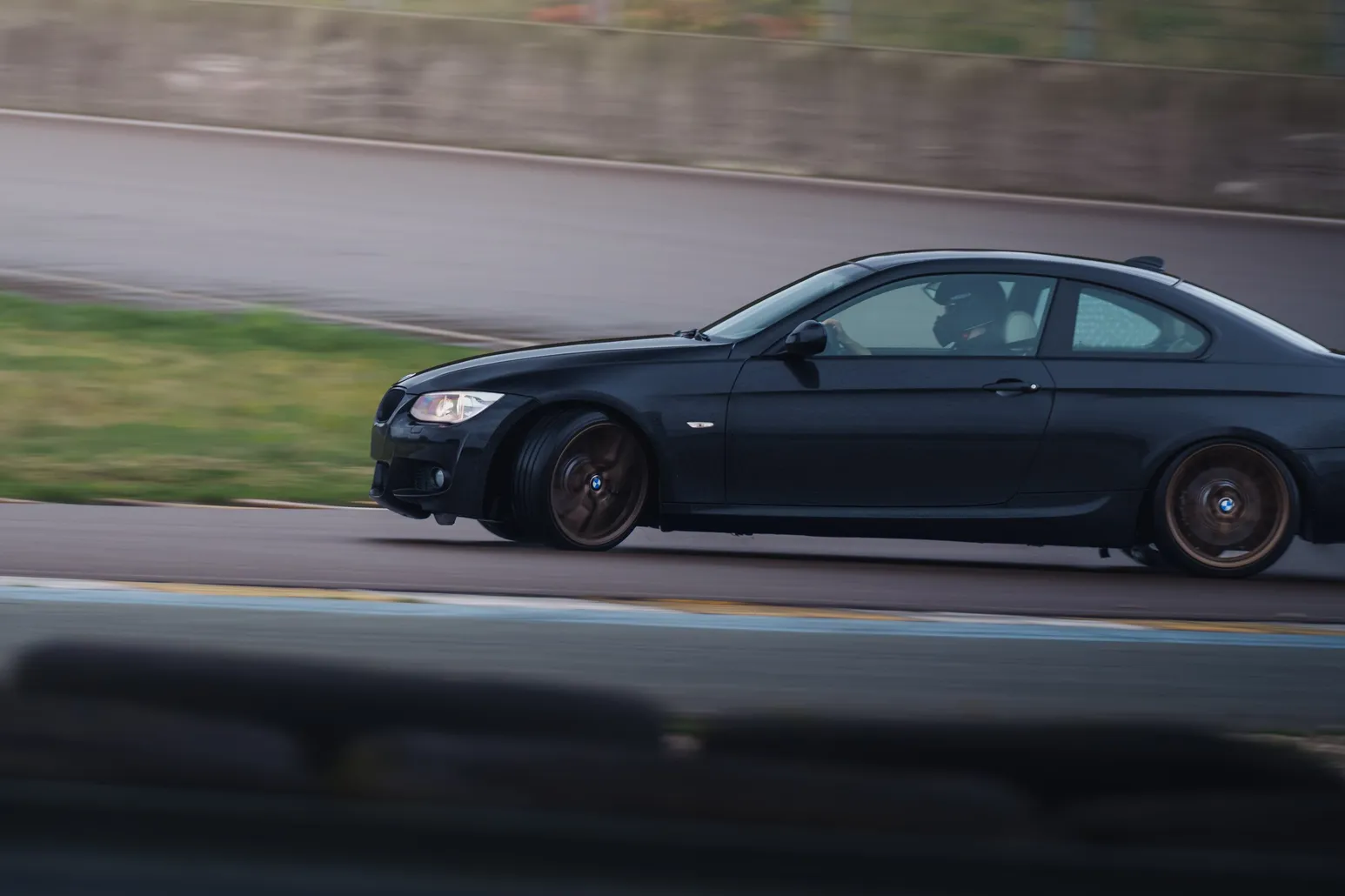 Black BMW 3 Series coupé (E92) panning shot