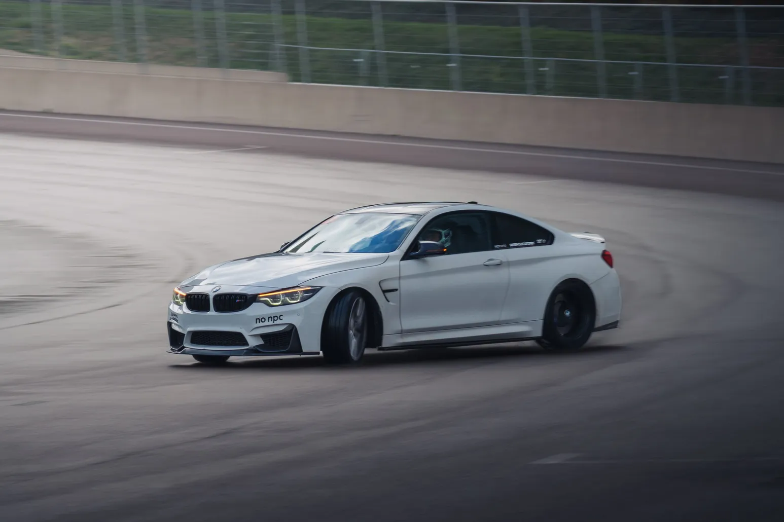 White BMW M4 (F82) drifting through a corner