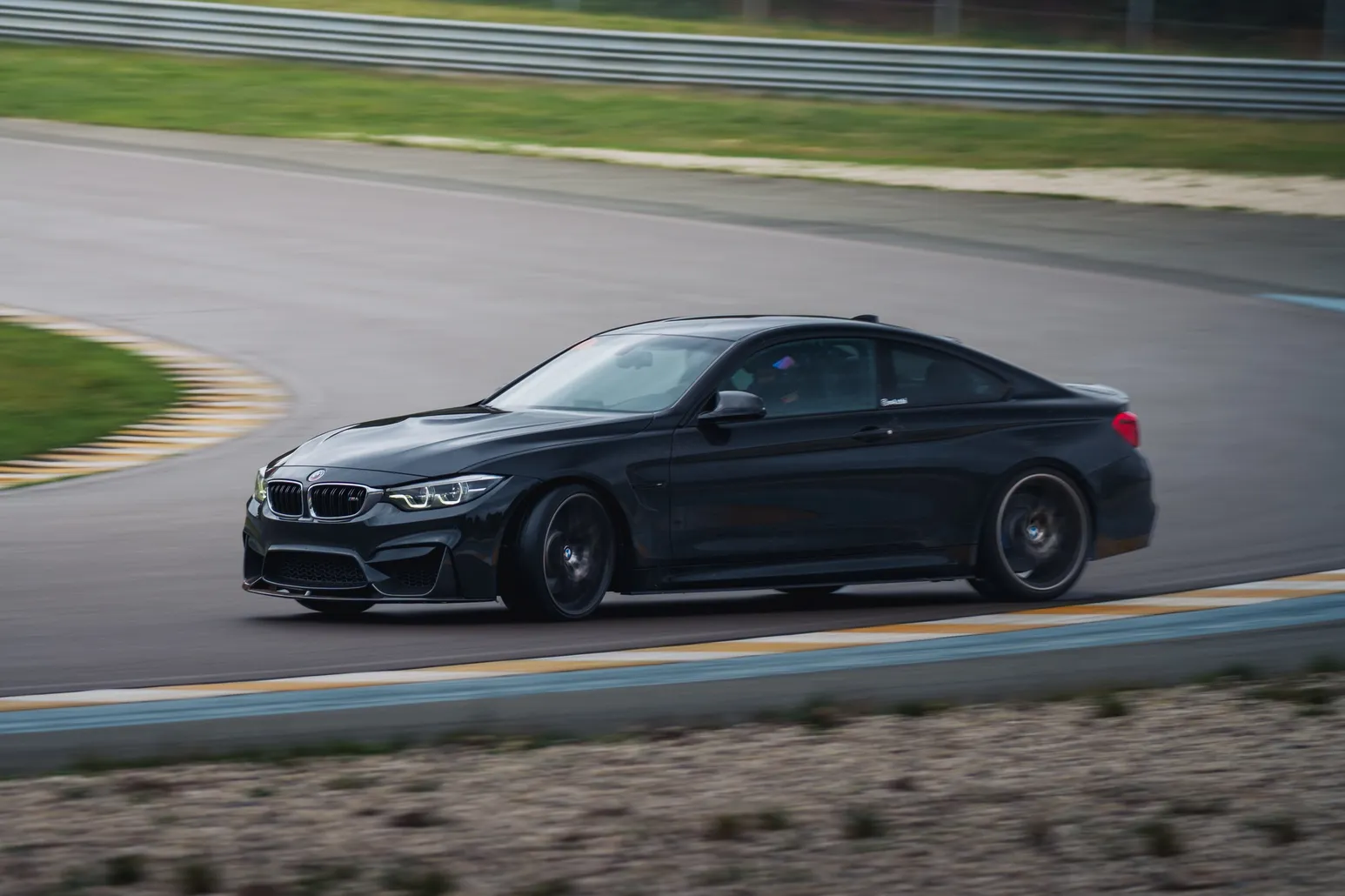 Black BMW M4 (F82) sideways in a corner