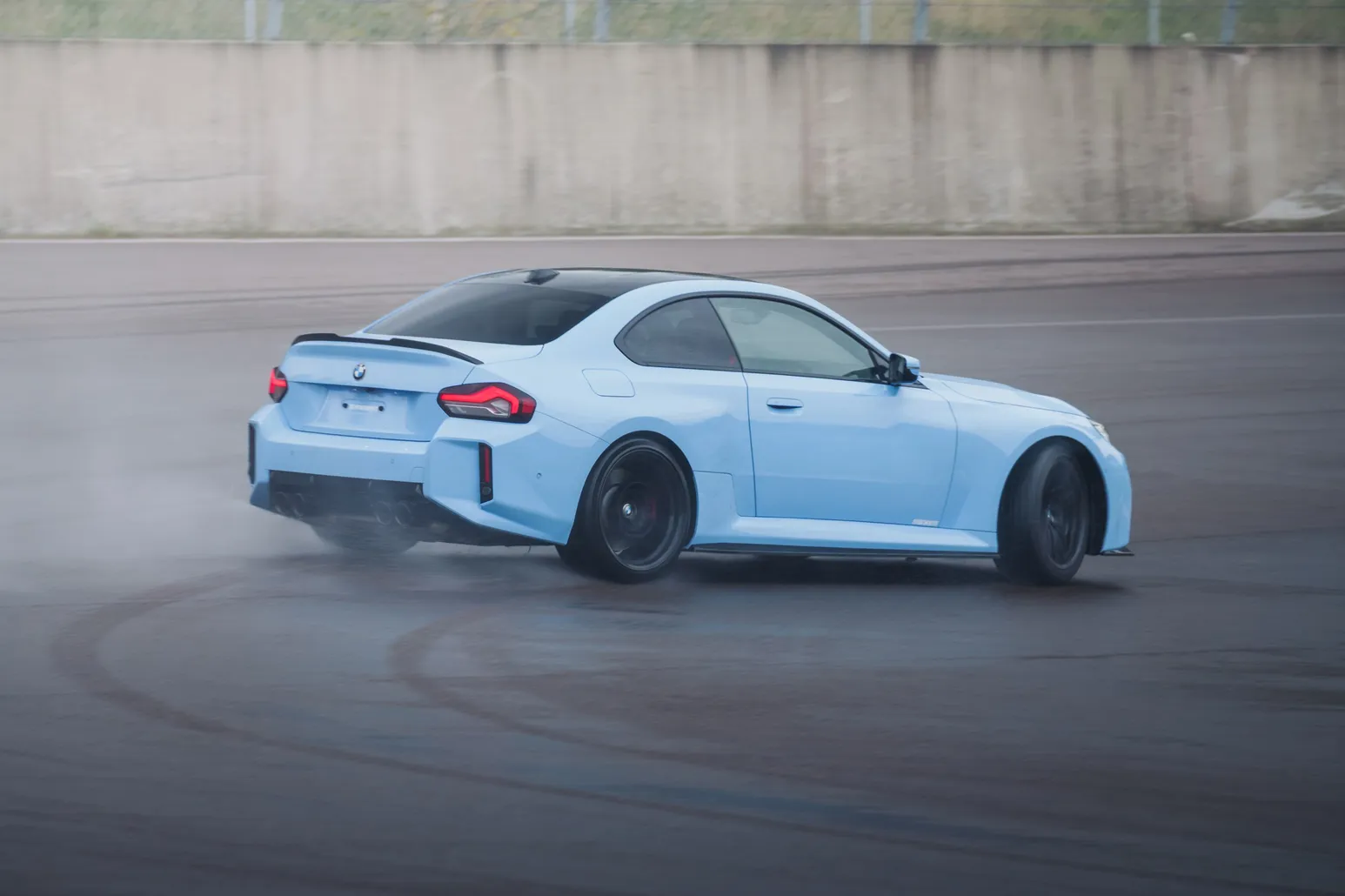 Light blue BMW M2 (G87) sideways on the wet track