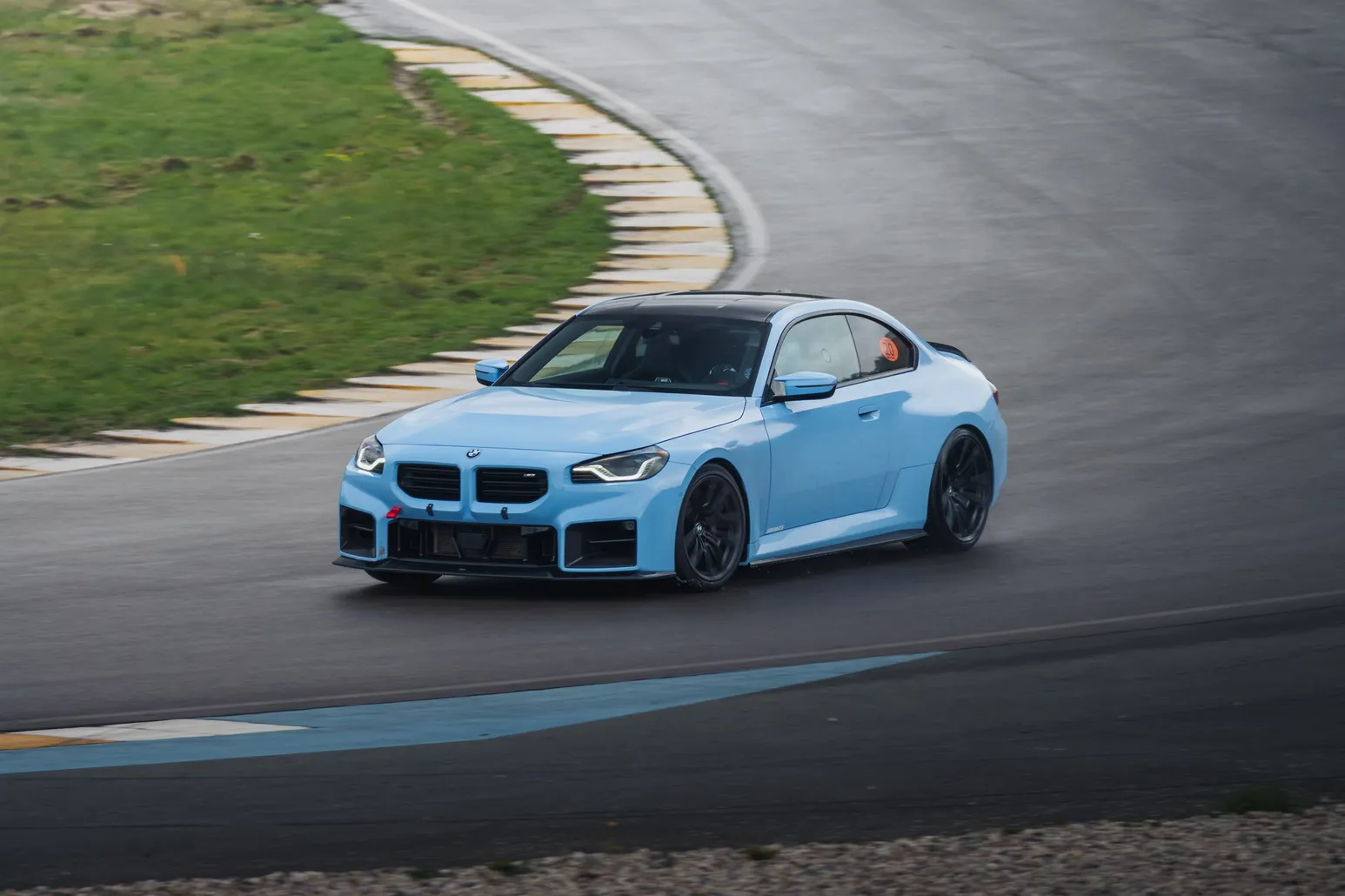 Light blue BMW M2 (G87) on corner exit