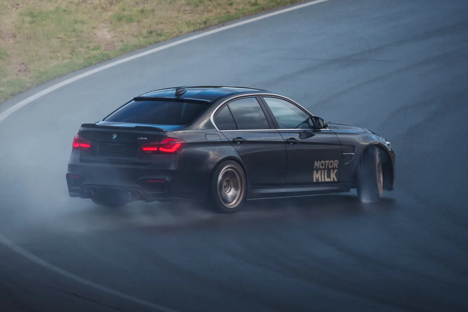Black BMW M3 (F80) drifting with spray
