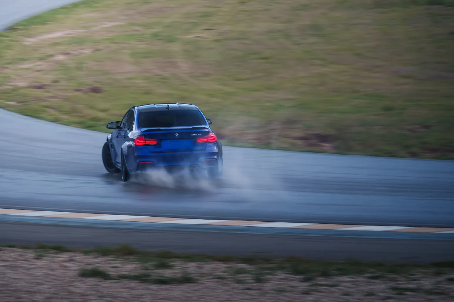Blue BMW M3 (F80) with smoke on corner exit