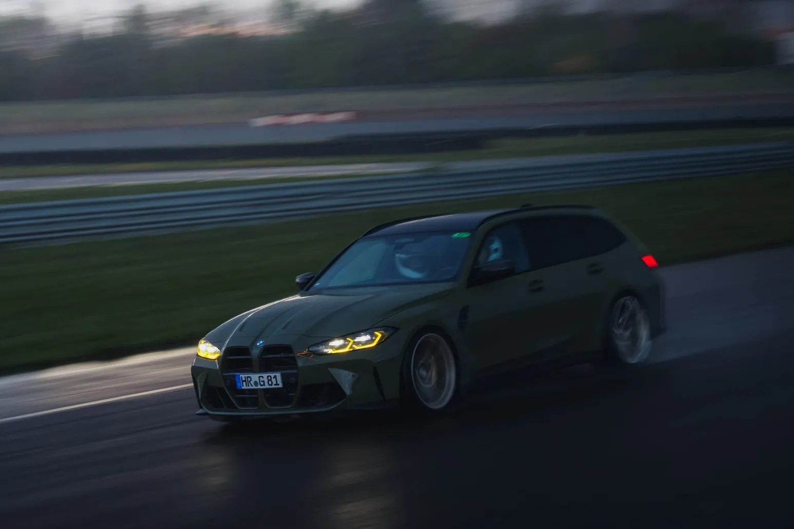 BMW M3 Touring at dusk on the wet track