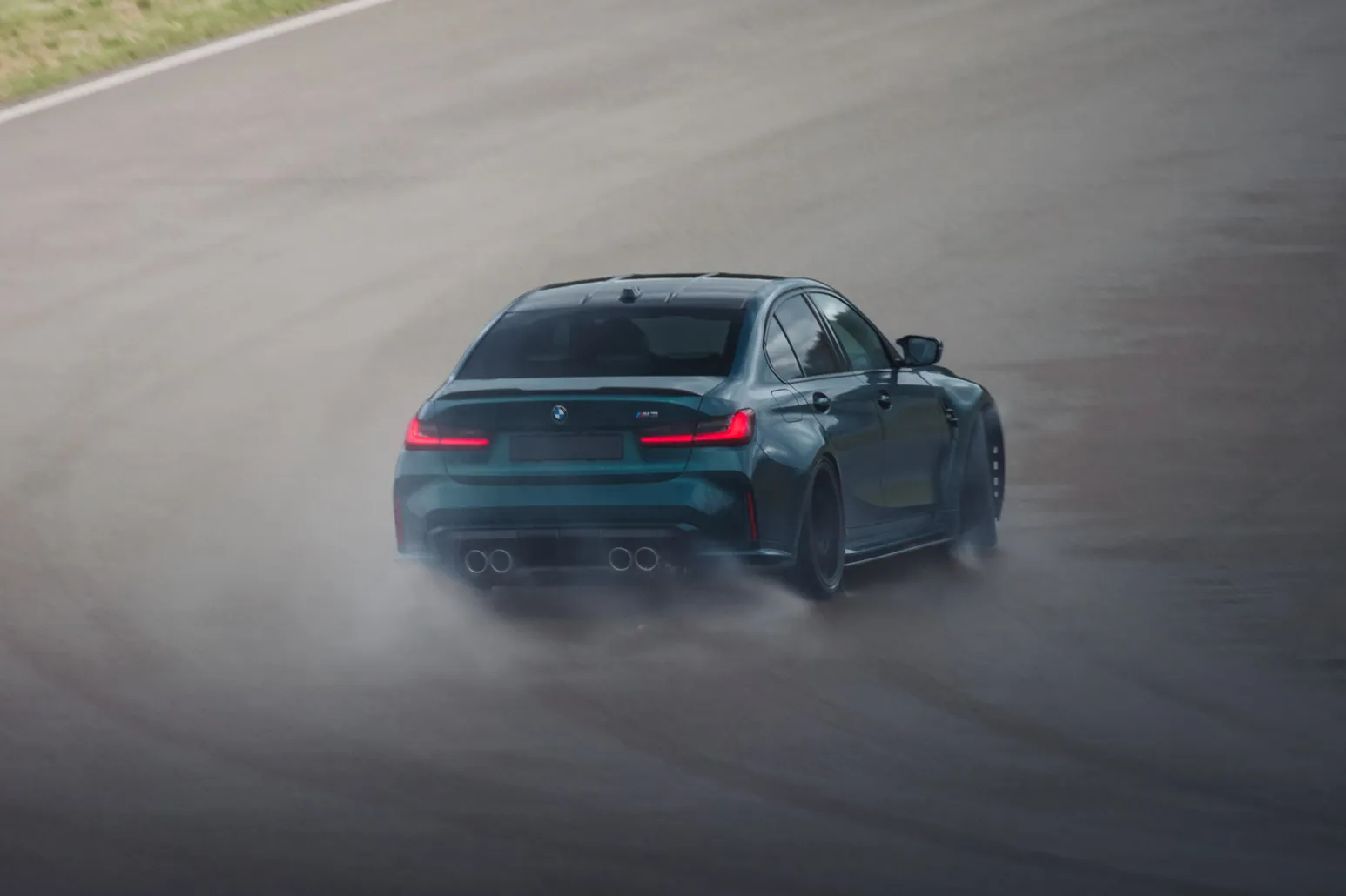 BMW M3 (G80) from behind with water mist