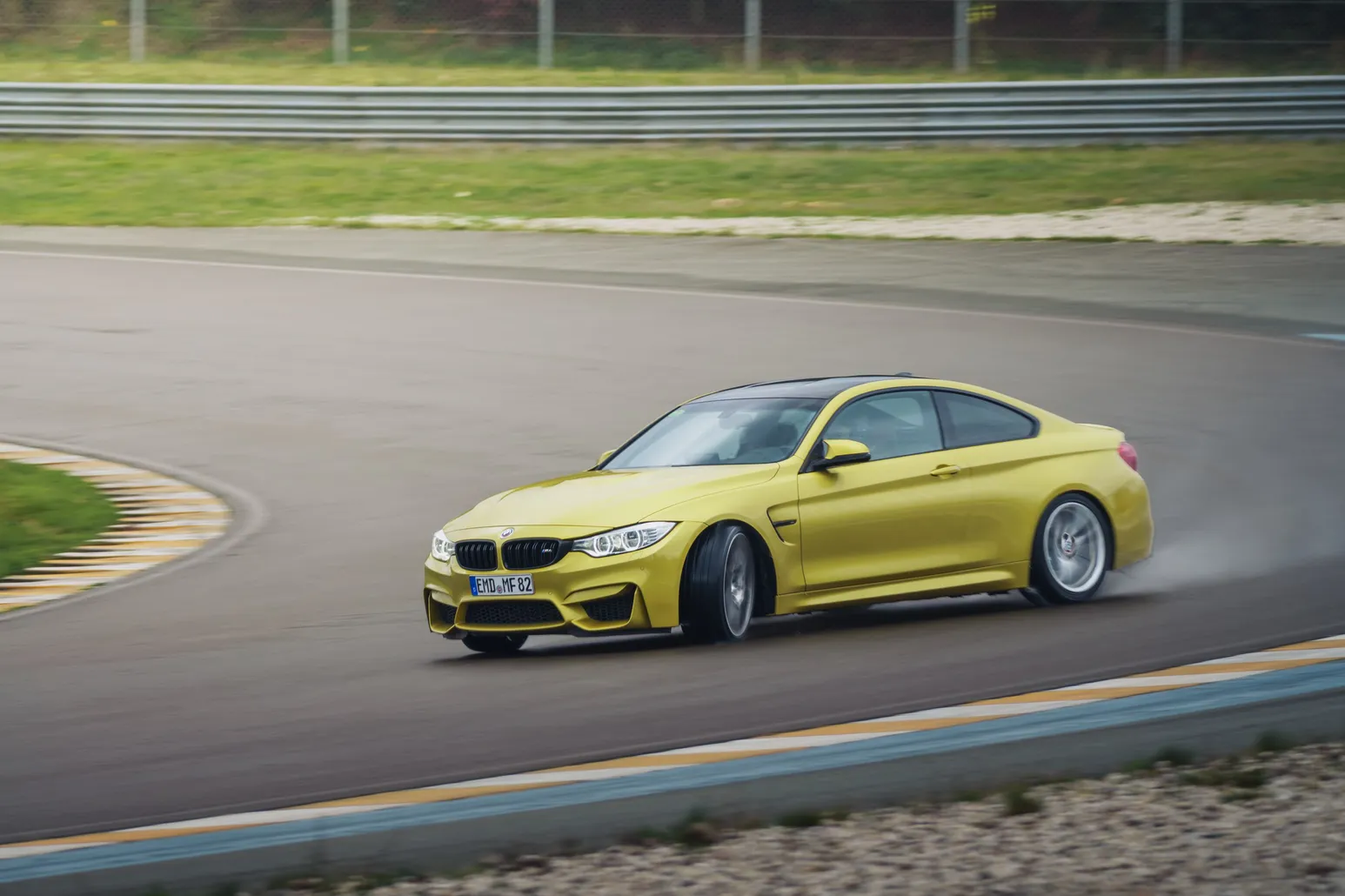 Yellow BMW M4 (F82) drifting with smoke