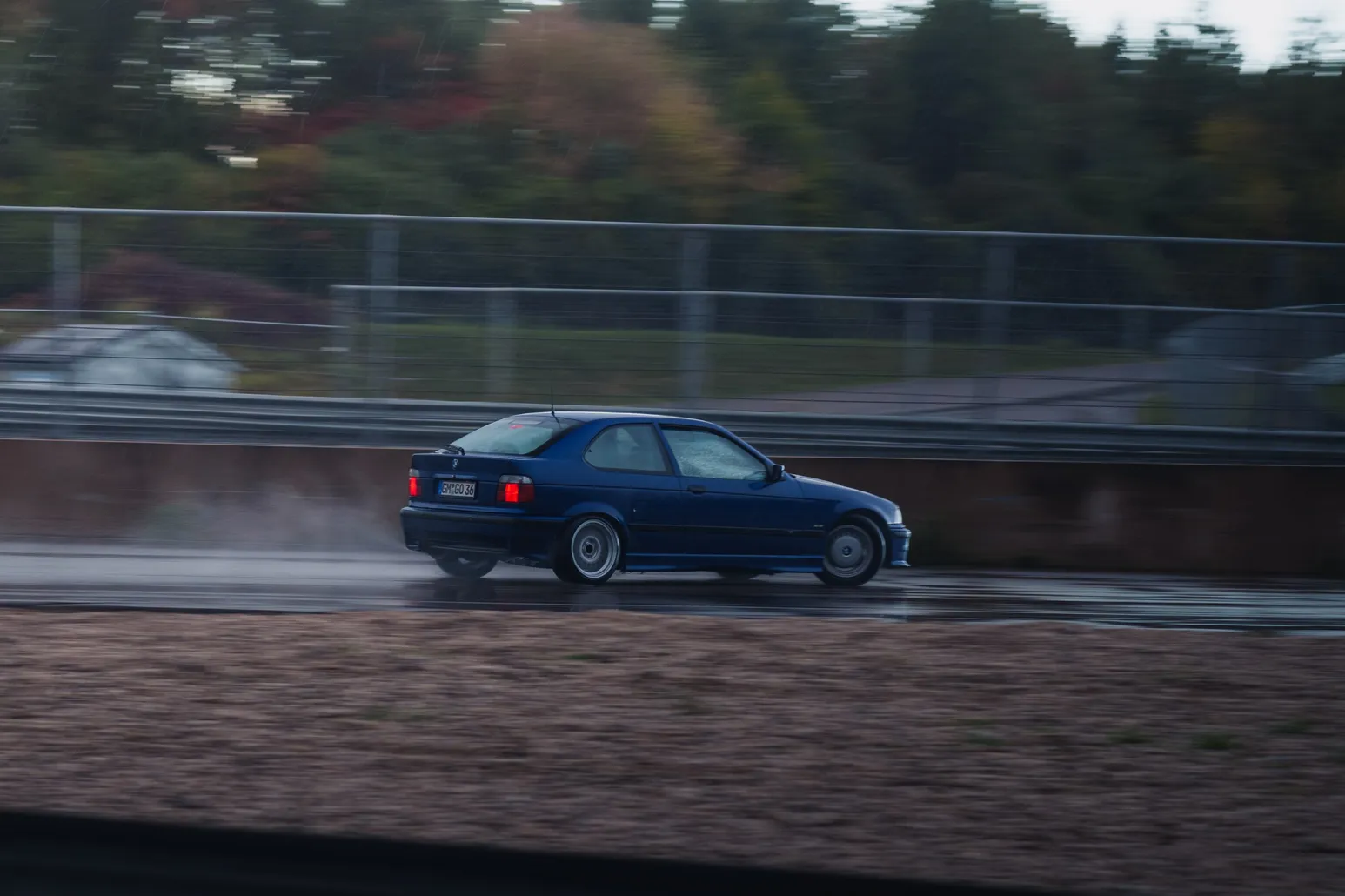 Blue BMW 3 Series Compact (E36) with spray
