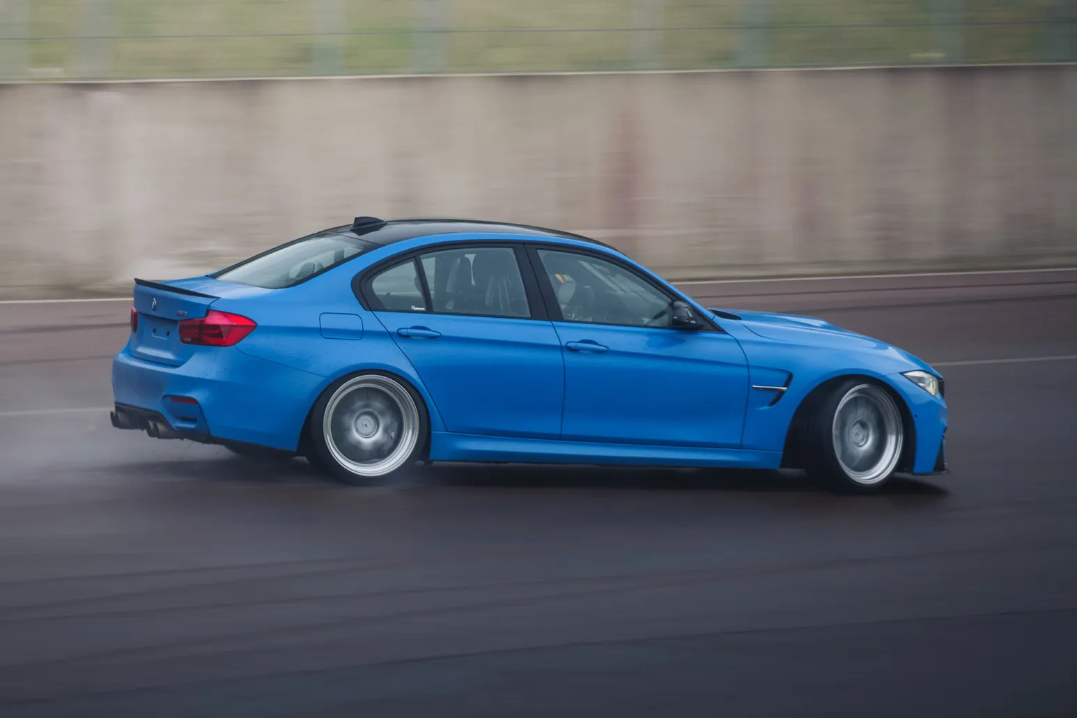 Blue BMW M3 (F80) drifting, side view