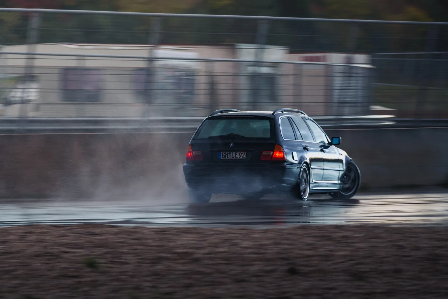 BMW 3 Series Touring (E91) drifting with spray and mud