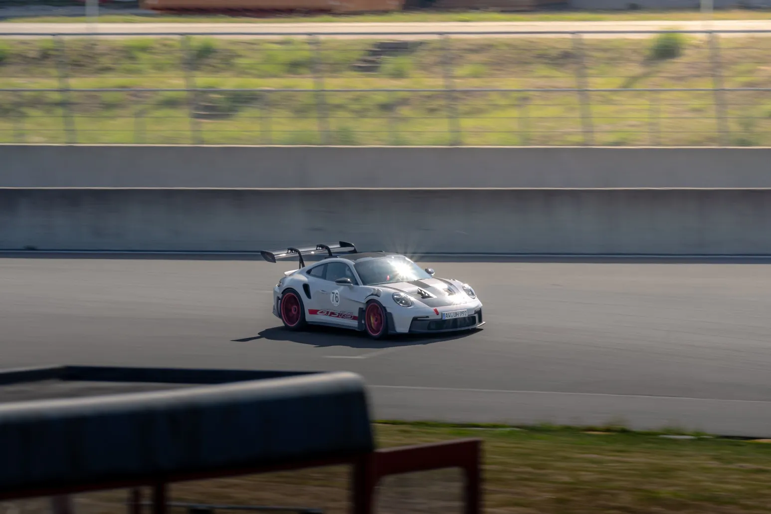 Weißer Porsche 911 GT3 RS mit roten Felgen auf der Geraden