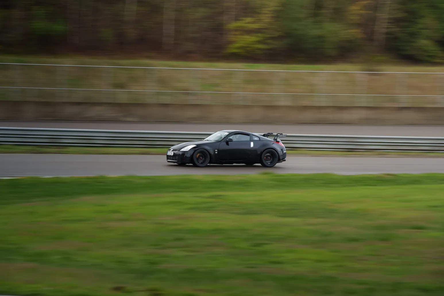 Black Nissan 350Z against green grass
