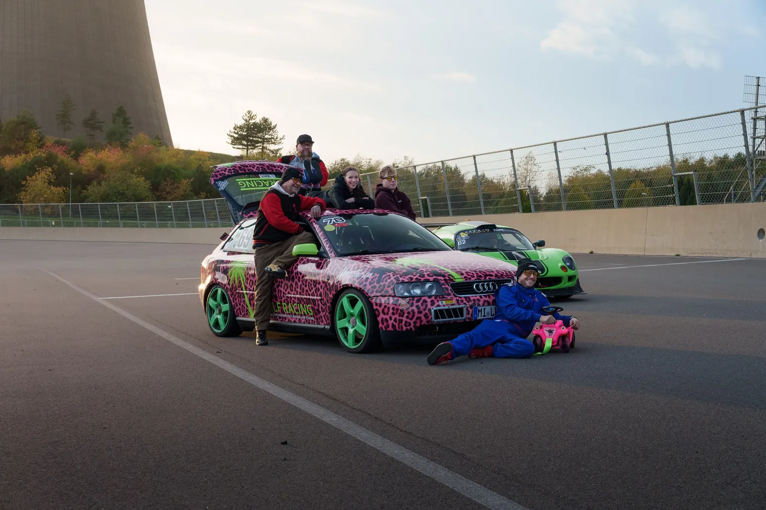Team posing on the leopard-print Audi A3