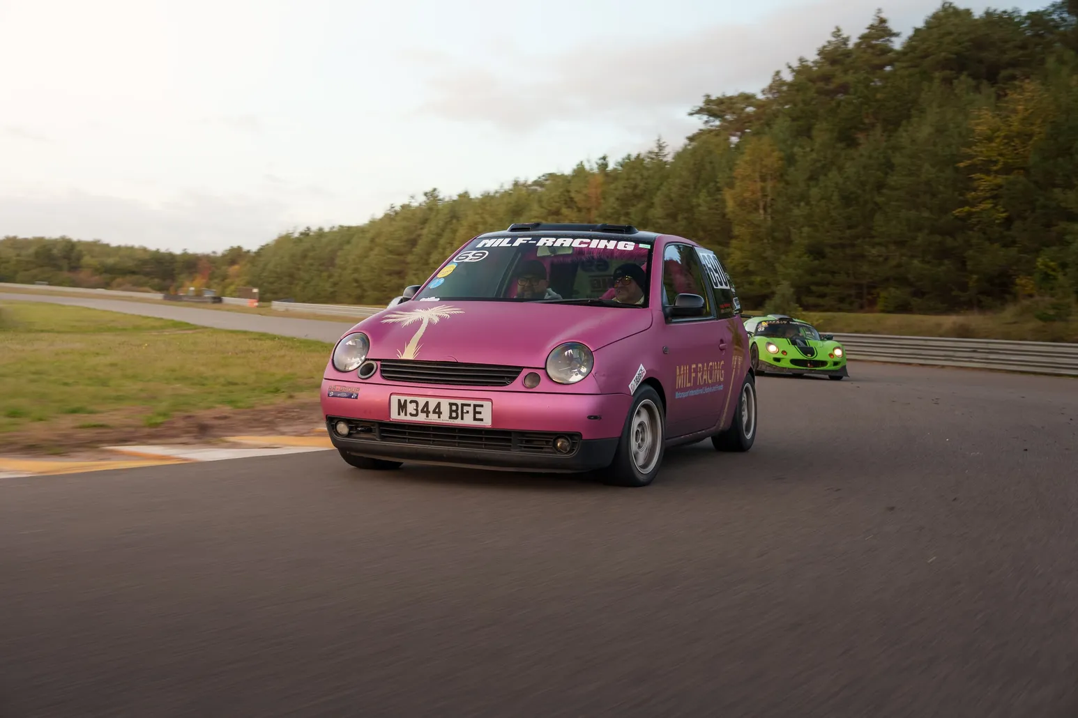 Pink VW Lupo with the green Lotus behind