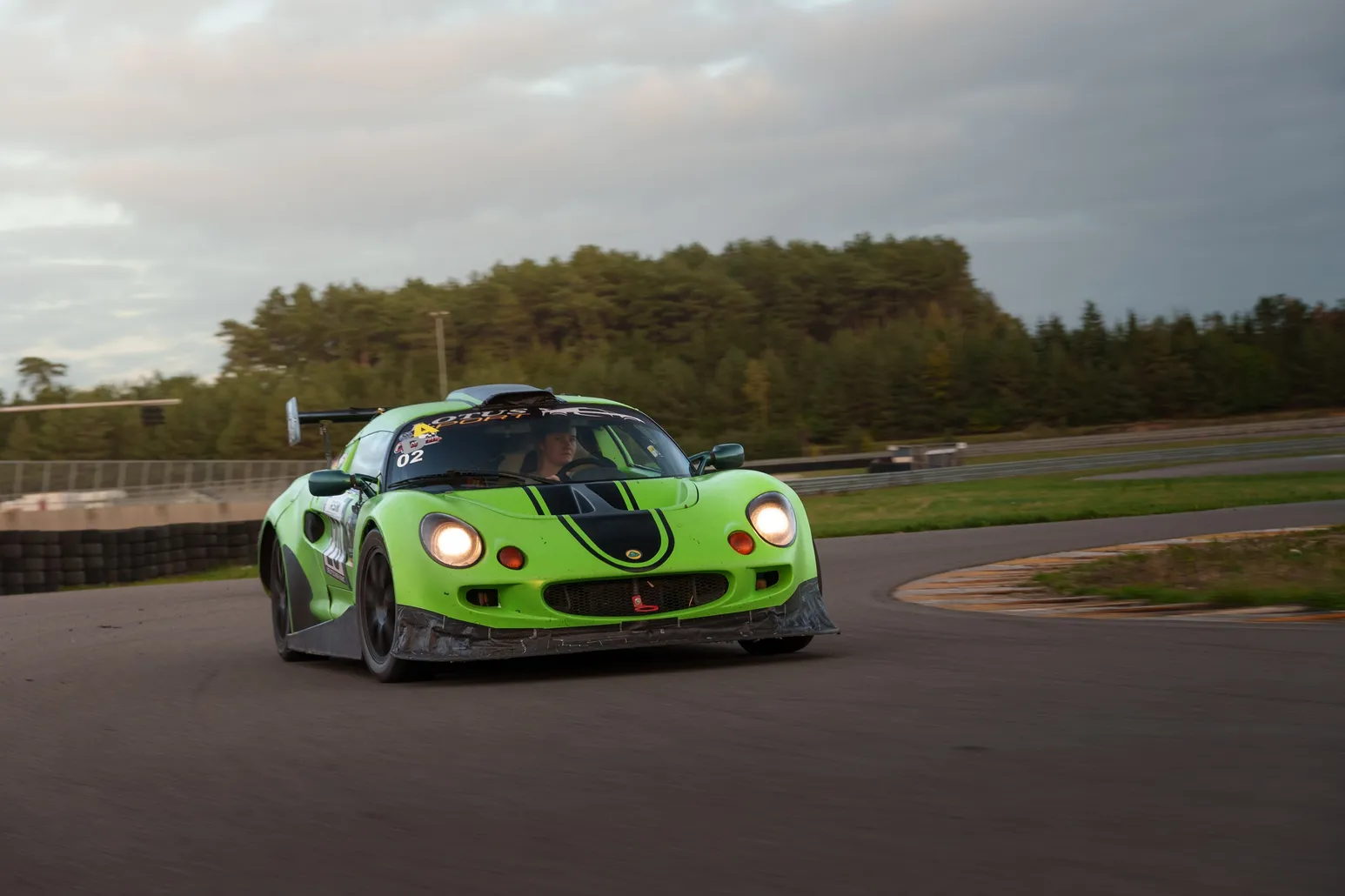 Green Lotus Elise up close with headlights on