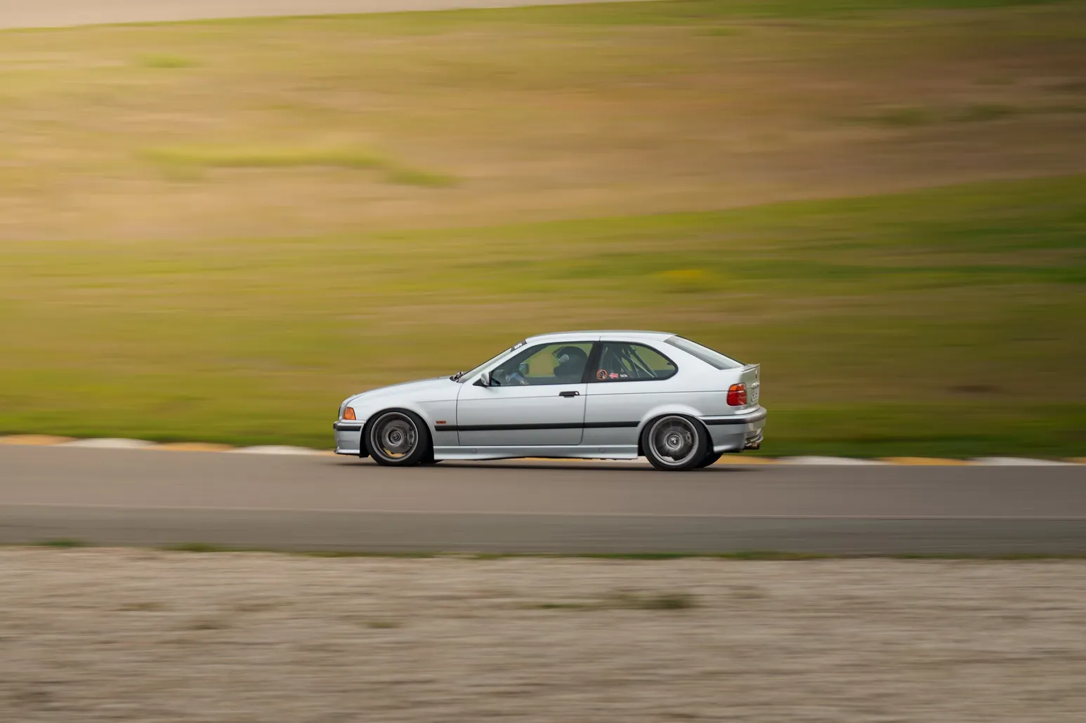 Silver BMW 3 Series Compact panning shot