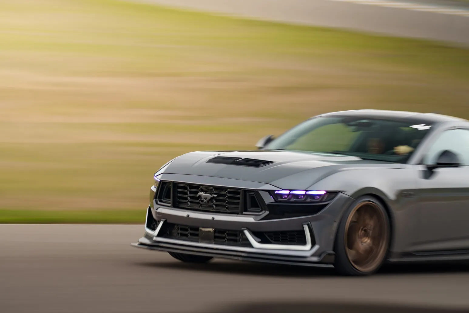 Ford Mustang Dark Horse up close in a panning shot