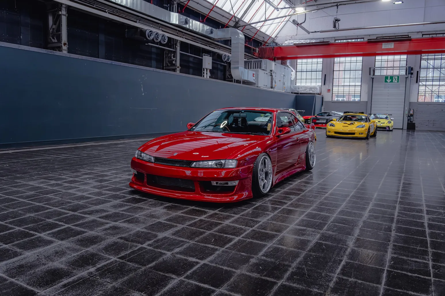 Red Nissan Silvia S14 in the wide industrial hall