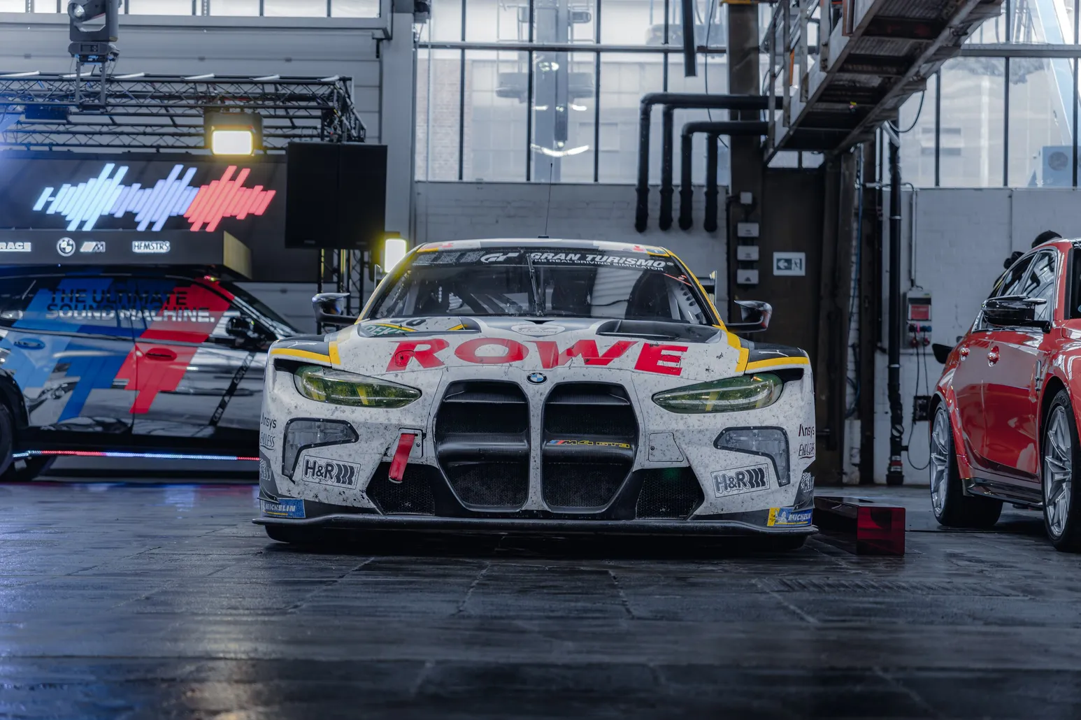 BMW M4 GT3 in ROWE livery head-on in the hall