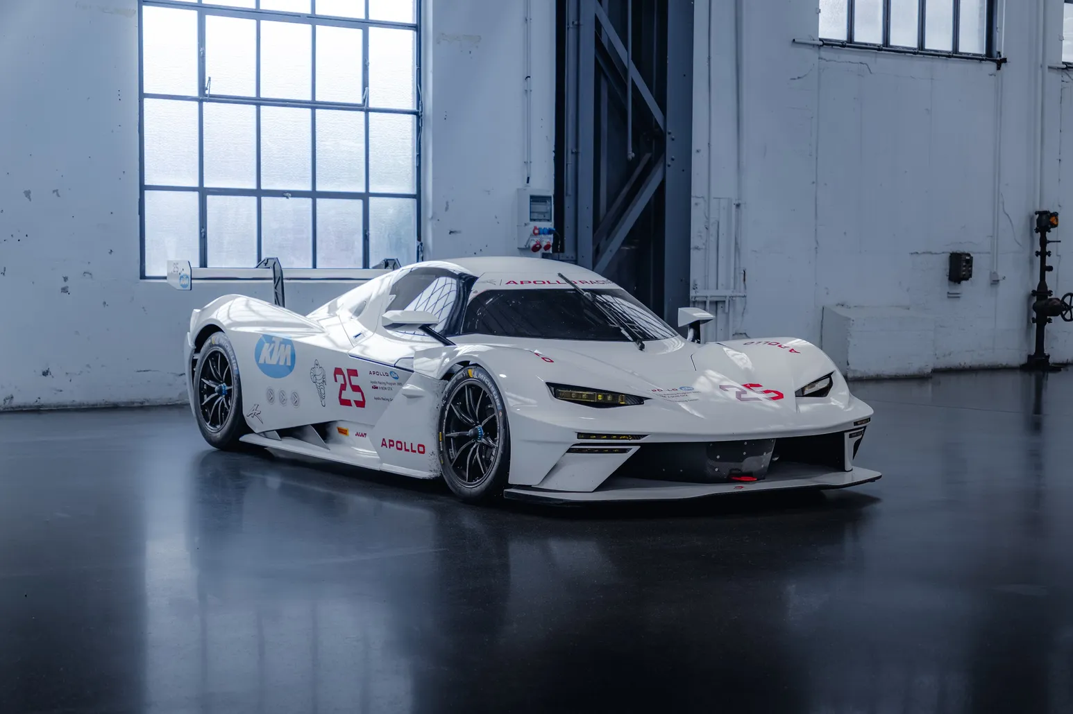 White KTM X-Bow GT2 in front of factory windows