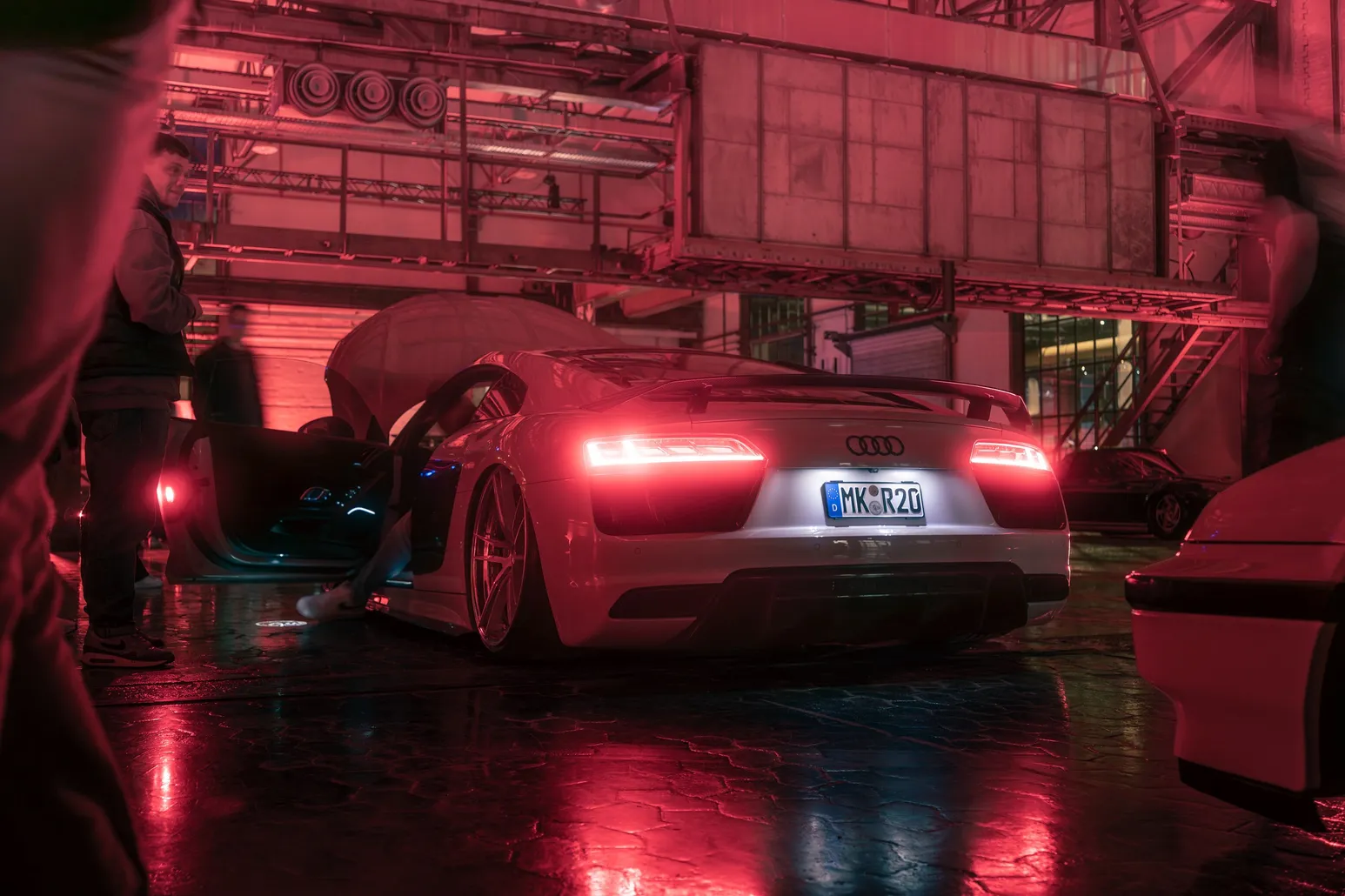 Audi R8 with glowing tail lights in red light