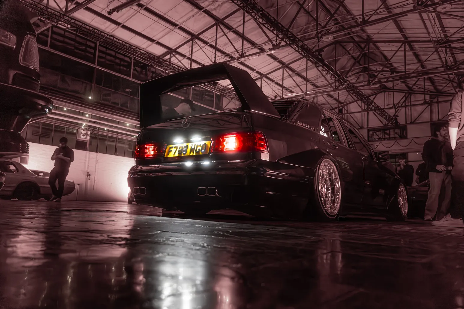 Classic BMW with a rear wing in the red hall light