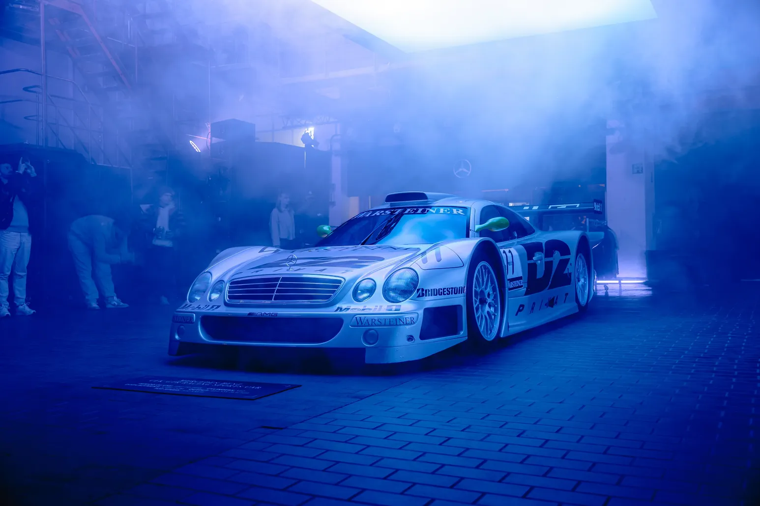 Silver Mercedes race car in blue haze