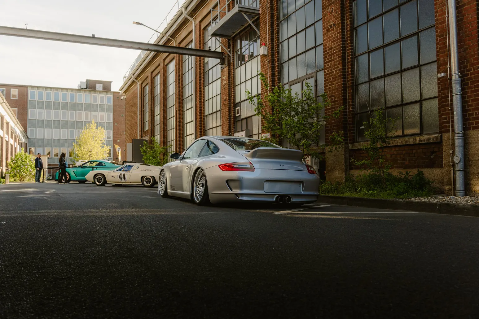 Silver Porsche 911 GT3 in front of a factory facade