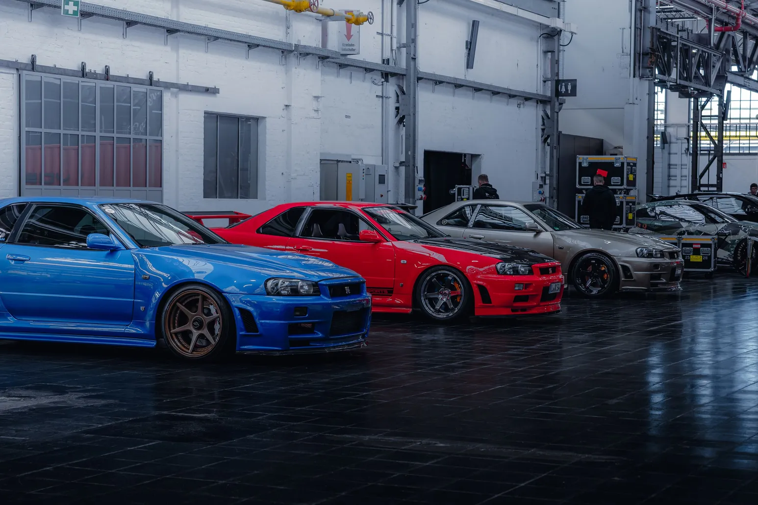 Blue, red and silver Nissan Skylines in a row