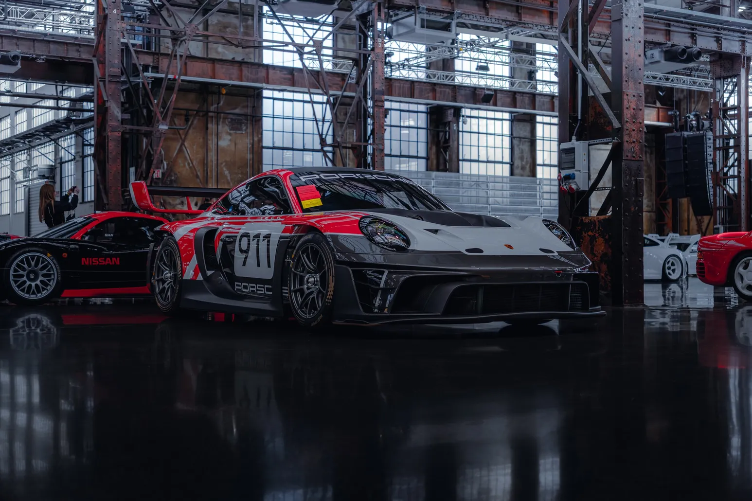 Red and black Porsche 911 GT3 R in the hall