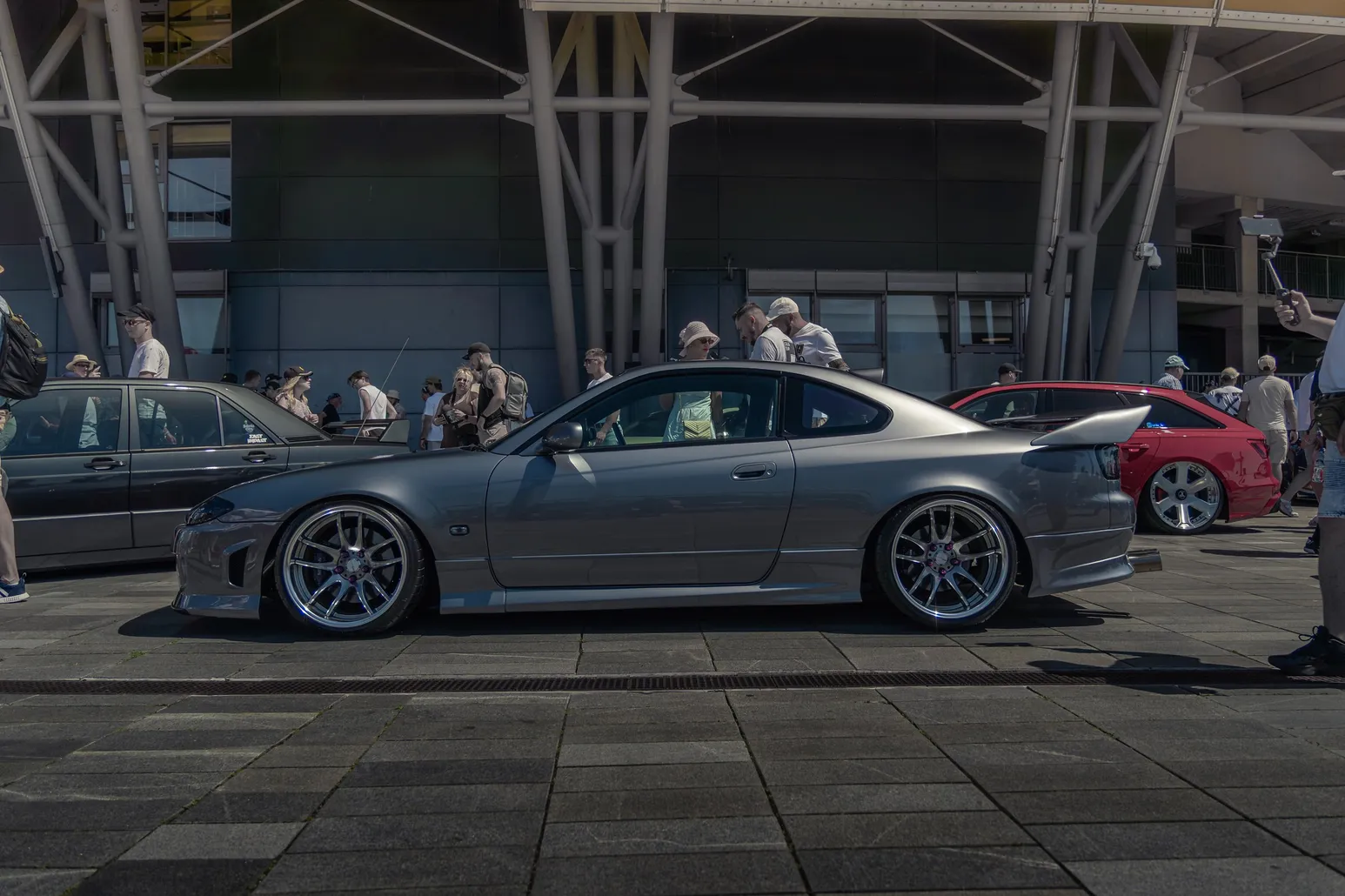 Grey Nissan Silvia S15 in front of the stadium structure